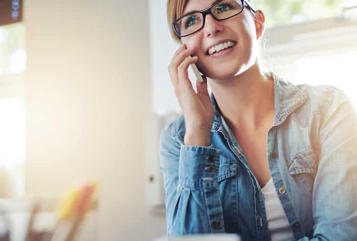 Happy woman wearing blue denim blouse hears a local bathroom tile estimate in Vallejo, California